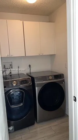 a kitchen with a sink a stove and cabinets