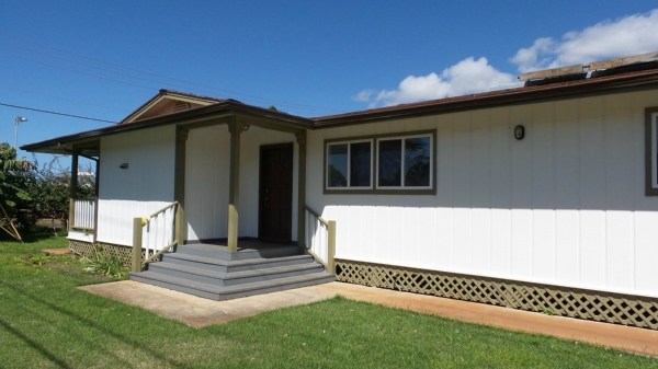 8205 Elepaio Road Kekaha, HI 96752 - Photo 3 of 16 a front view of a house with a garden