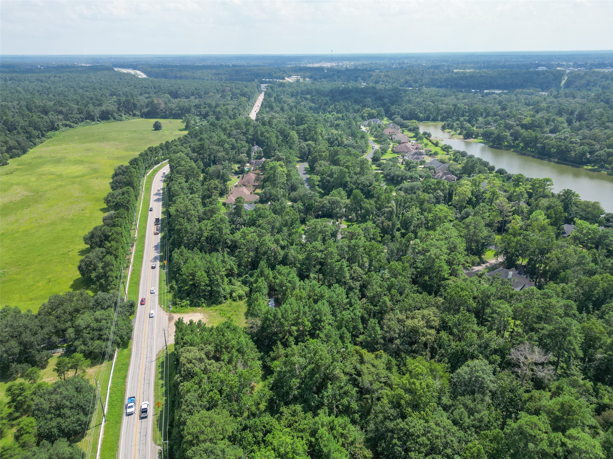 37119 Farm To Market 149 Pinehurst, TX 77362 - Photo 5 of 10 an aerial view of a city with lots of residential buildings and mountain view in back