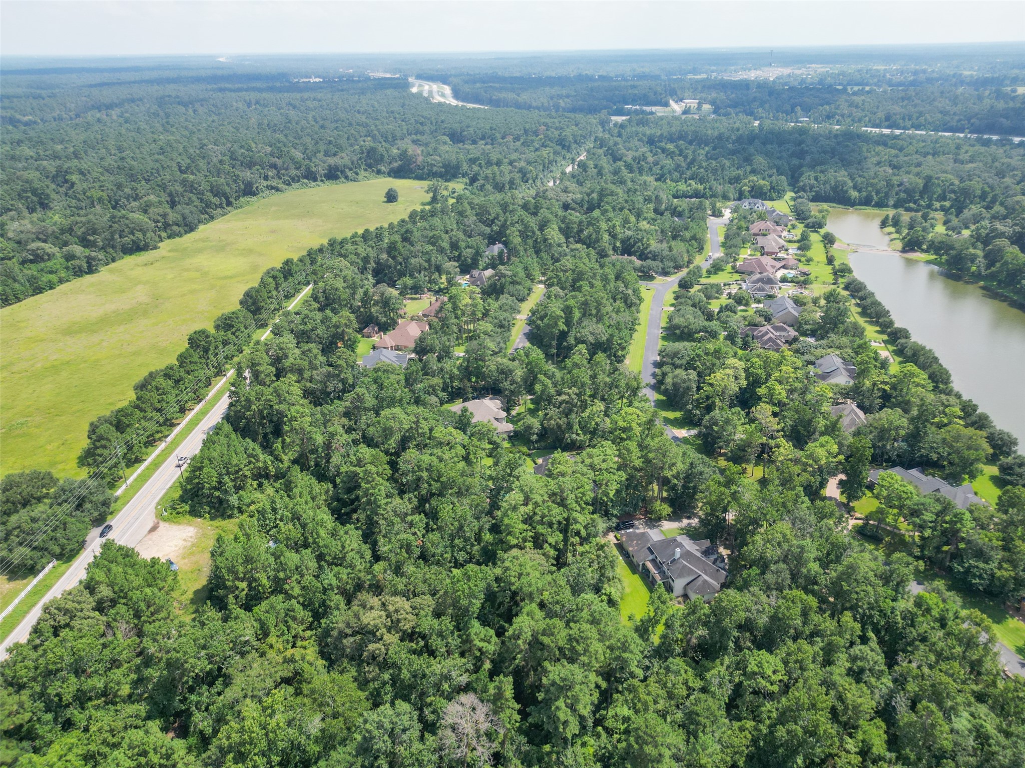 37119 Farm To Market 149 Pinehurst, TX 77362 - Photo 6 of 10 a view of a city with lush green forest