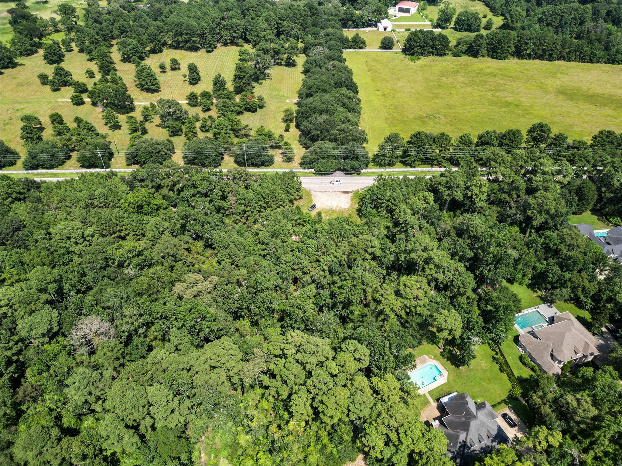 37119 Farm To Market 149 Pinehurst, TX 77362 - Photo 8 of 10 a view of a lake with a building in the background