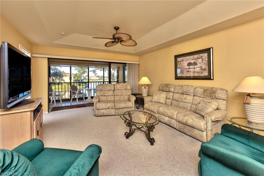 4410 Chantelle Drive, Unit H206 Naples, FL 34112 - Photo 11 of 25 a living room with furniture and a flat screen tv