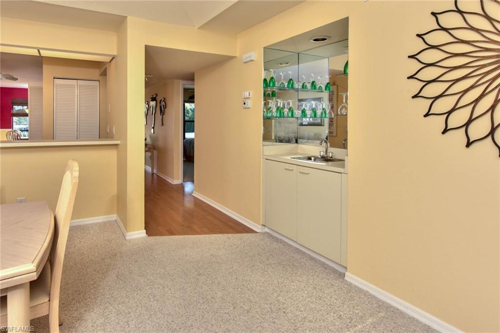 4410 Chantelle Drive, Unit H206 Naples, FL 34112 - Photo 16 of 25 a view of a kitchen cabinets and wooden floor