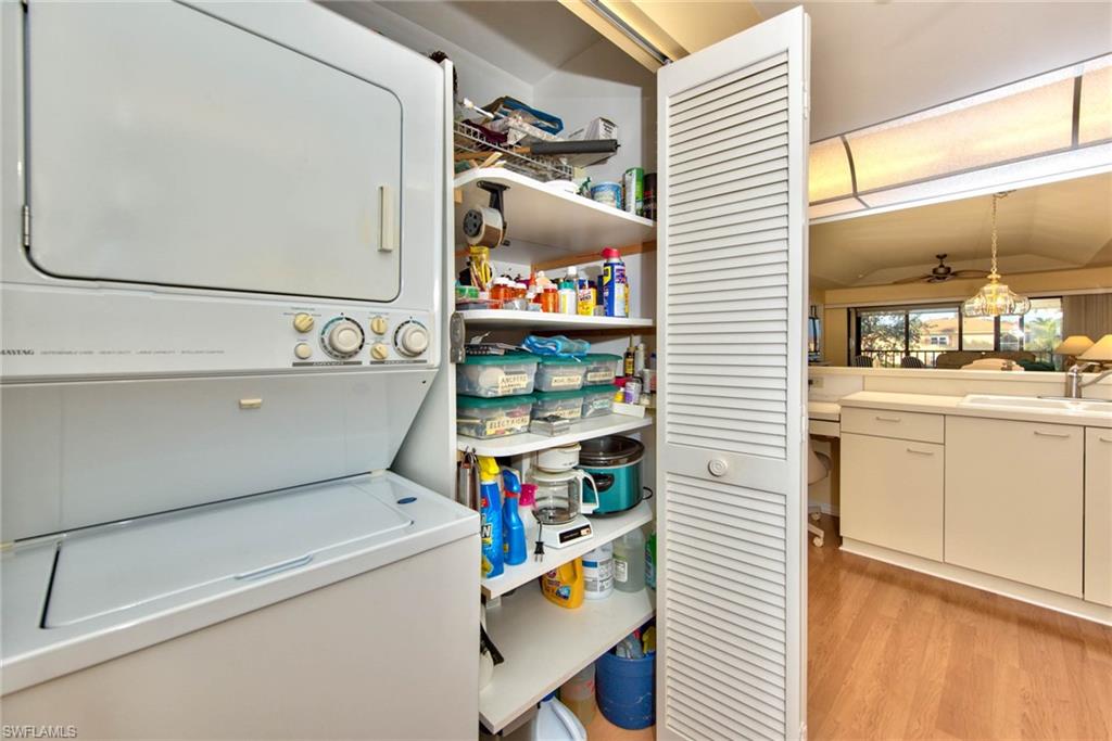 4410 Chantelle Drive, Unit H206 Naples, FL 34112 - Photo 22 of 25 a utility room with dryer and washer