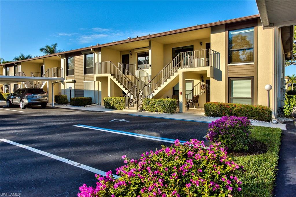 4410 Chantelle Drive, Unit H206 Naples, FL 34112 - Photo 23 of 25 a front view of building with flowers