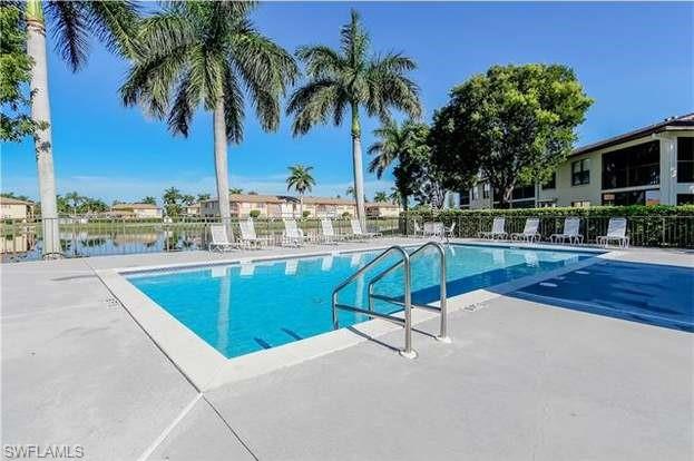 4410 Chantelle Drive, Unit H206 Naples, FL 34112 - Photo 24 of 25 a view of a swimming pool with a lounge chairs