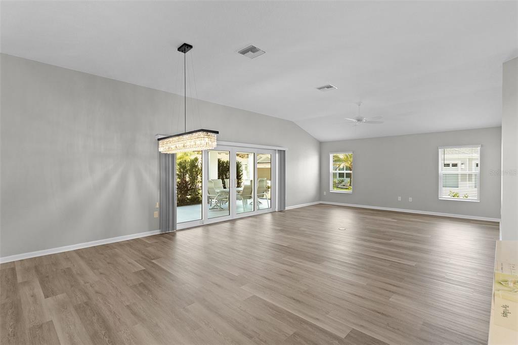 1177 Elkington Road The Villages, FL 34762 - Photo 14 of 59 a view of an empty room with window and wooden floor