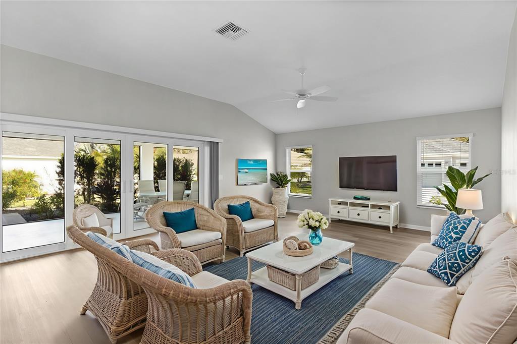 1177 Elkington Road The Villages, FL 34762 - Photo 15 of 59 a living room with furniture a flat screen tv and a large window