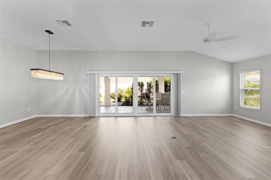 1177 Elkington Road The Villages, FL 34762 - Photo 16 of 59 an empty room with wooden floor and windows