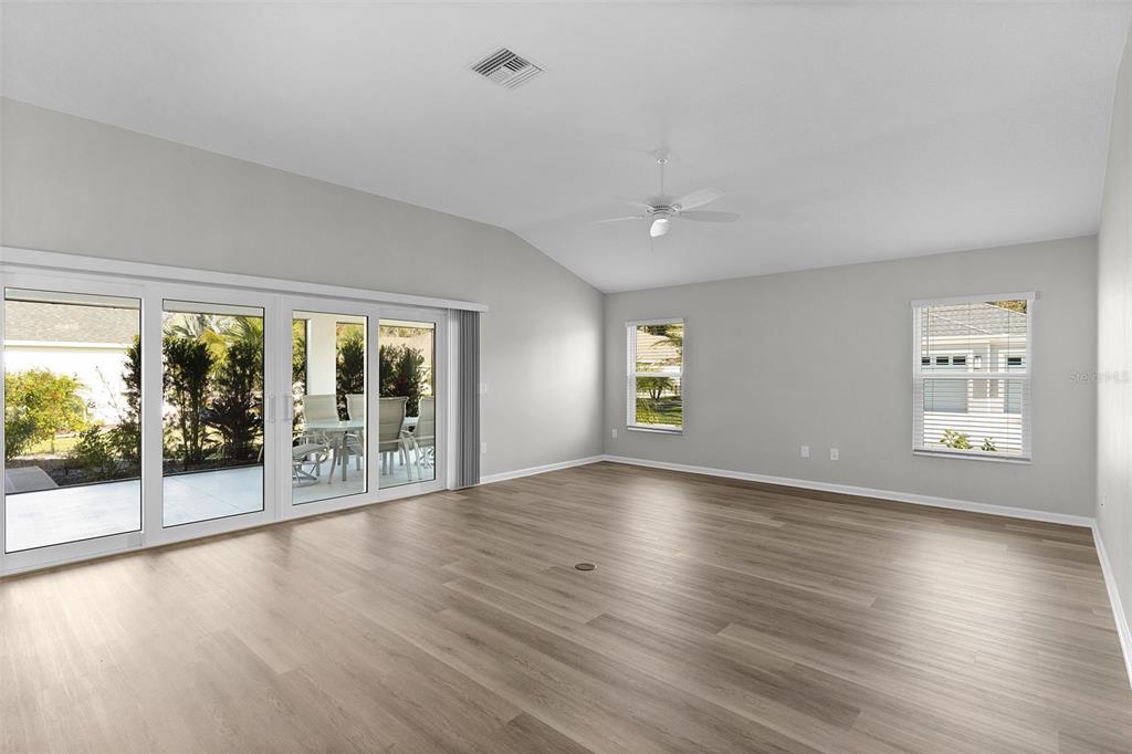 1177 Elkington Road The Villages, FL 34762 - Photo 17 of 59 a view of an empty room with wooden floor and a window