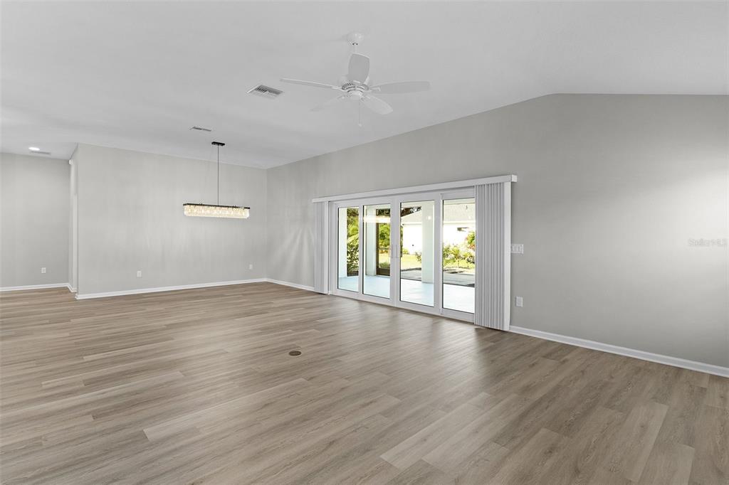 1177 Elkington Road The Villages, FL 34762 - Photo 18 of 59 a view of an empty room with wooden floor and a window