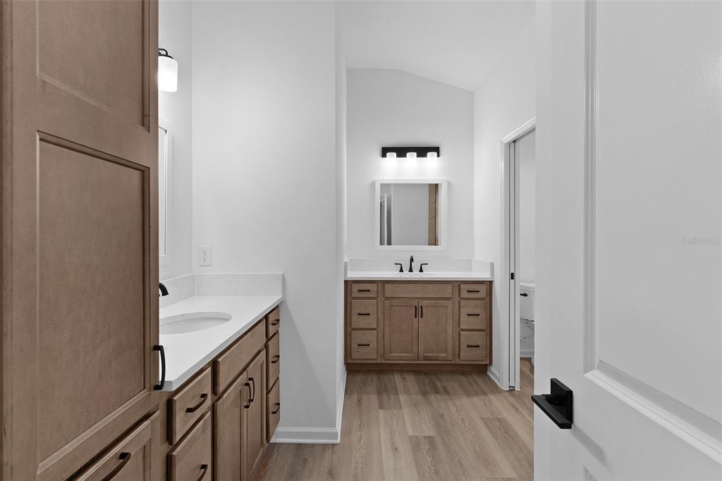 1177 Elkington Road The Villages, FL 34762 - Photo 23 of 59 a spacious bathroom with a double vanity sink a mirror and a bathtub