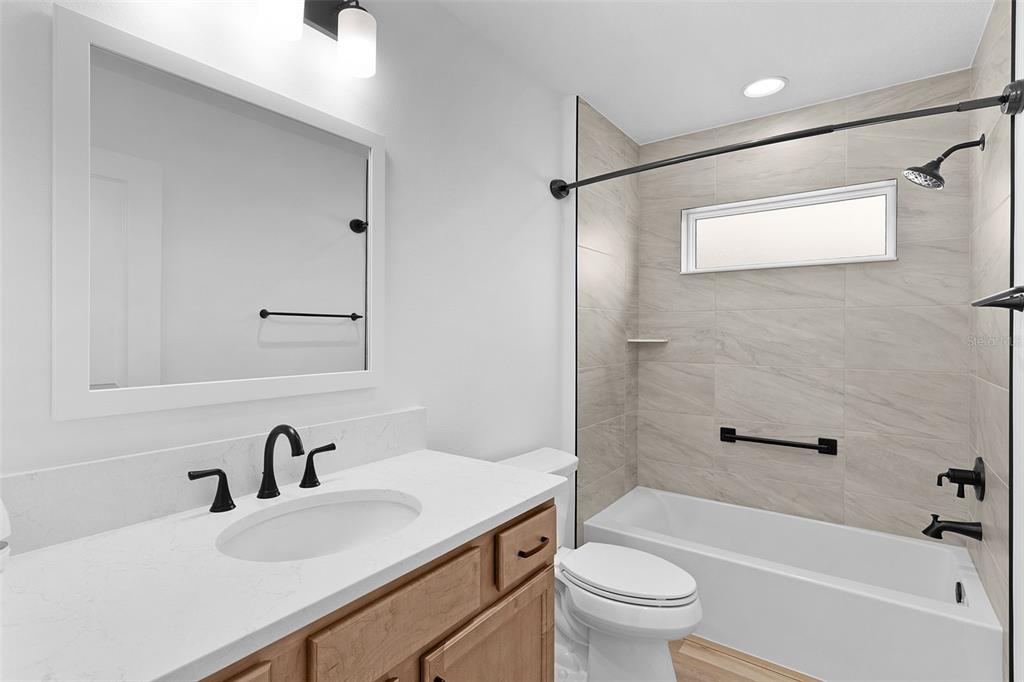 1177 Elkington Road The Villages, FL 34762 - Photo 32 of 59 a bathroom with a sink toilet and shower