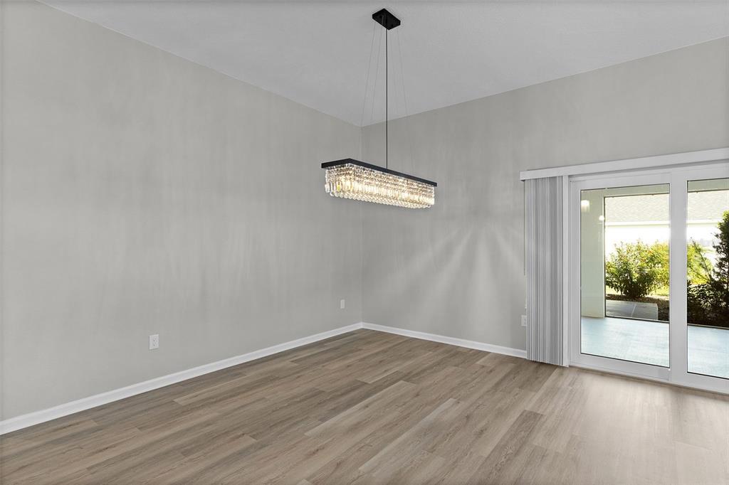 1177 Elkington Road The Villages, FL 34762 - Photo 43 of 59 a view of a room with wooden floor and a window