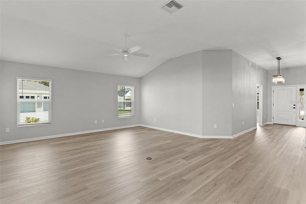 1177 Elkington Road The Villages, FL 34762 - Photo 44 of 59 an empty room with wooden floor and windows