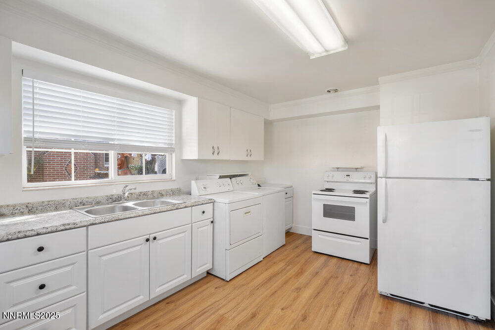 80 Locust Street Reno, NV 89502 - Photo 12 of 49 a kitchen with white cabinets and white appliances