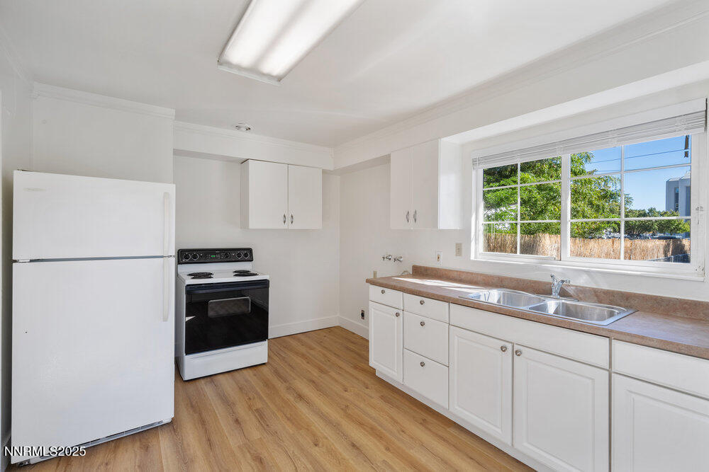 80 Locust Street Reno, NV 89502 - Photo 32 of 49 a kitchen with granite countertop appliances a sink and a window