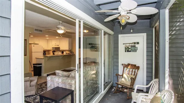 a view of a hallway with livingroom and dining area with chandelier