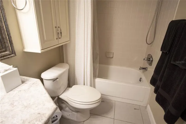 a white toilet sitting next to a bath tub