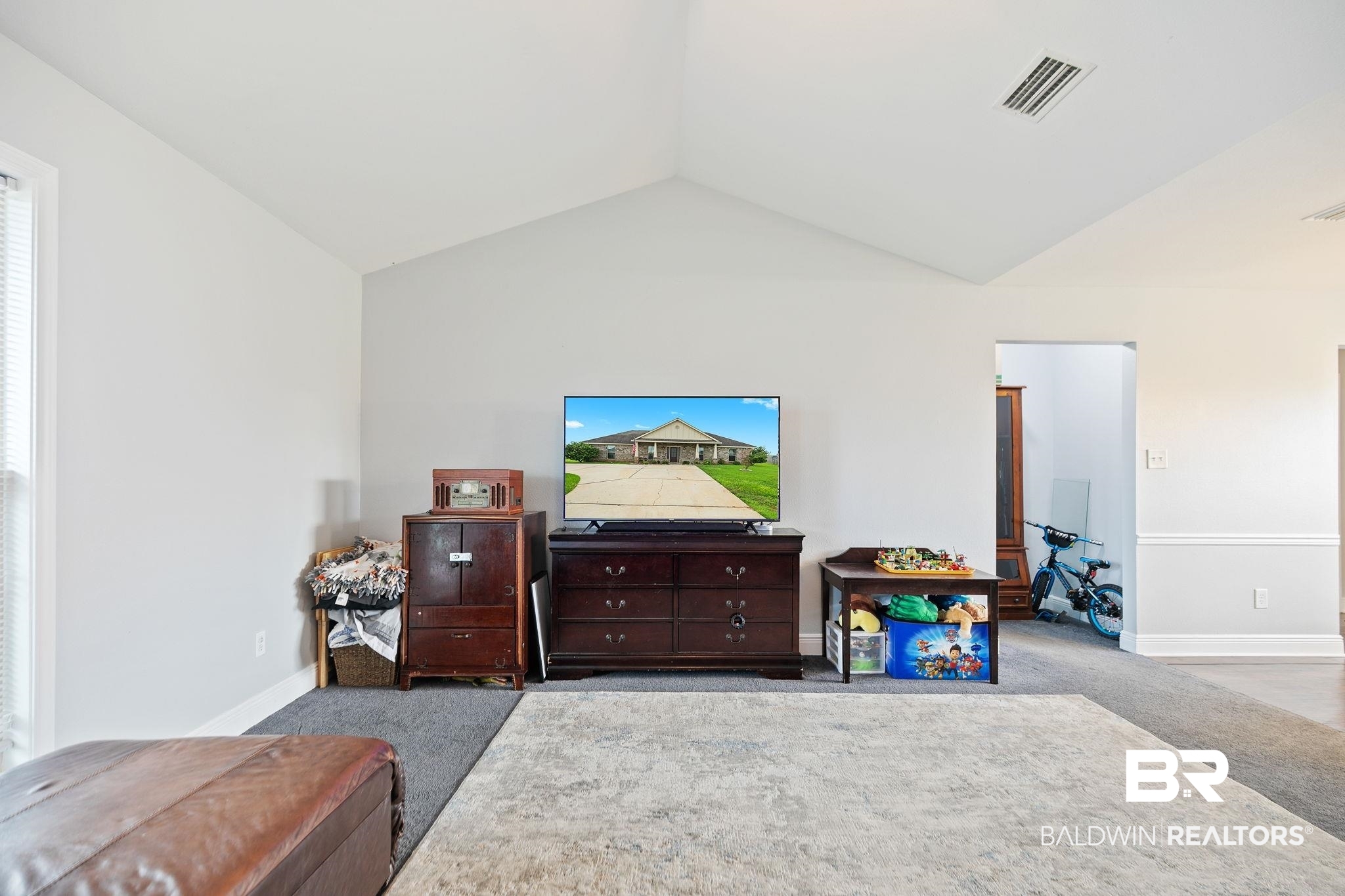 15573 Talus Court Foley, AL 36535 - Photo 13 of 50 Interior space with vaulted ceiling and light colored carpet