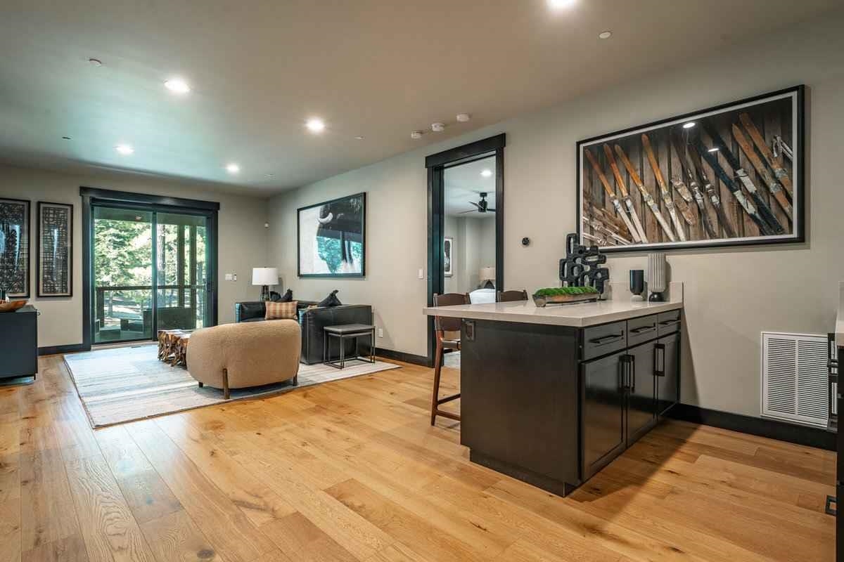 1055 Martis Landing, Unit B Truckee, CA 96161 - Photo 19 of 24 a living room with stainless steel appliances granite countertop furniture a fireplace a rug kitchen view and a window