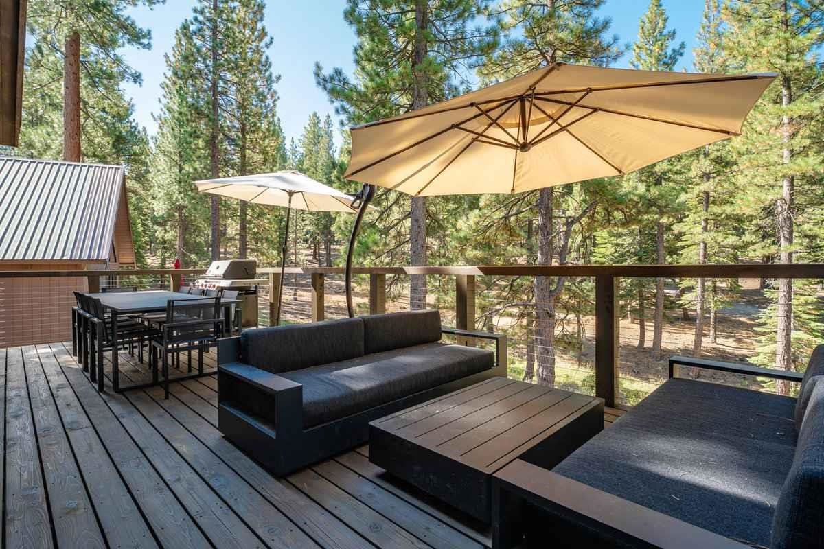 1055 Martis Landing, Unit B Truckee, CA 96161 - Photo 23 of 24 an outdoor sitting area with furniture and umbrella