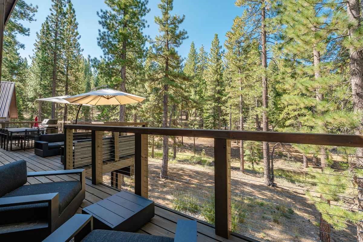 1055 Martis Landing, Unit B Truckee, CA 96161 - Photo 24 of 24 a balcony with wooden floor table and chairs