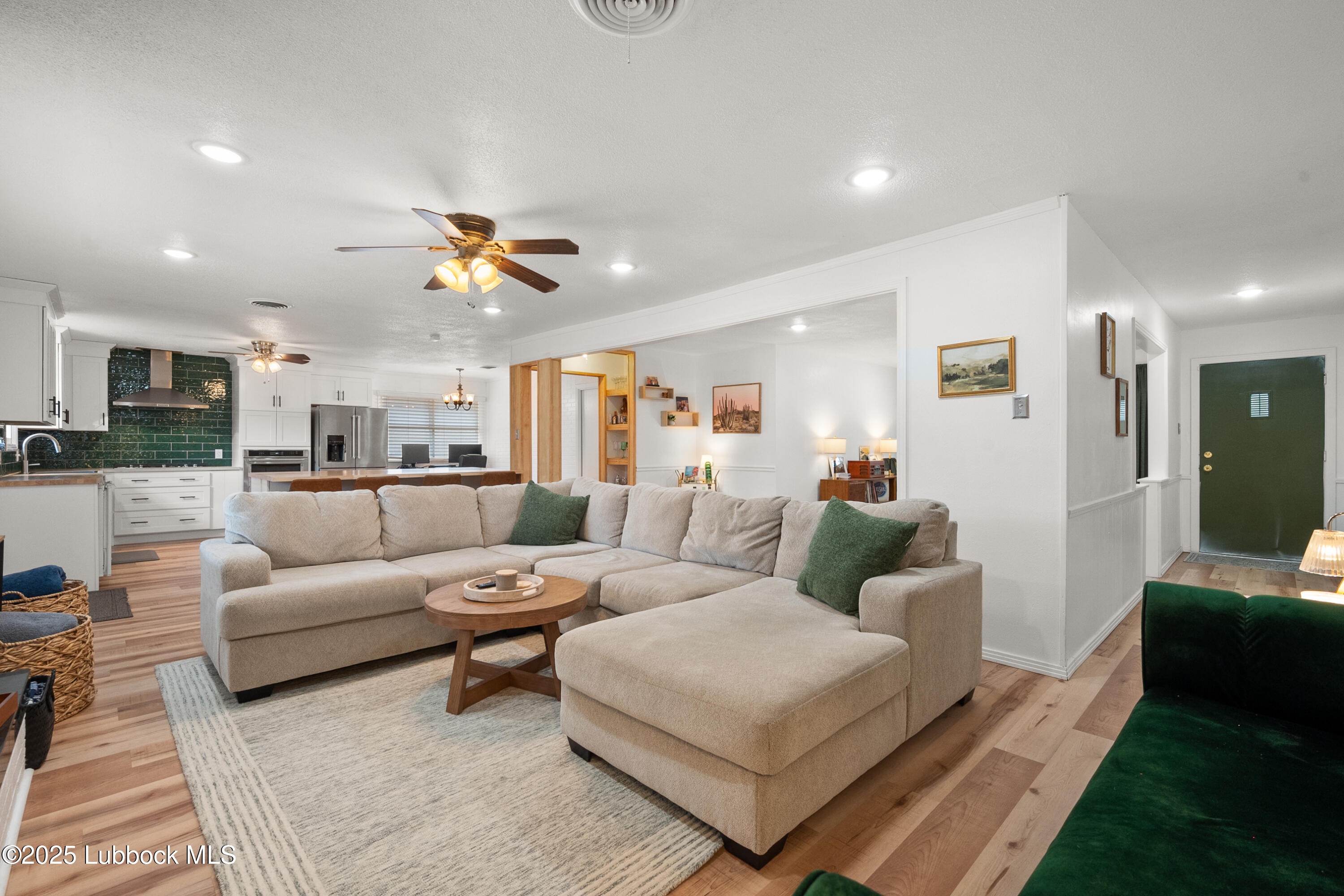 6405 Joliet Avenue Lubbock, TX 79413 - Photo 11 of 30 a living room with furniture kitchen view and a chandelier