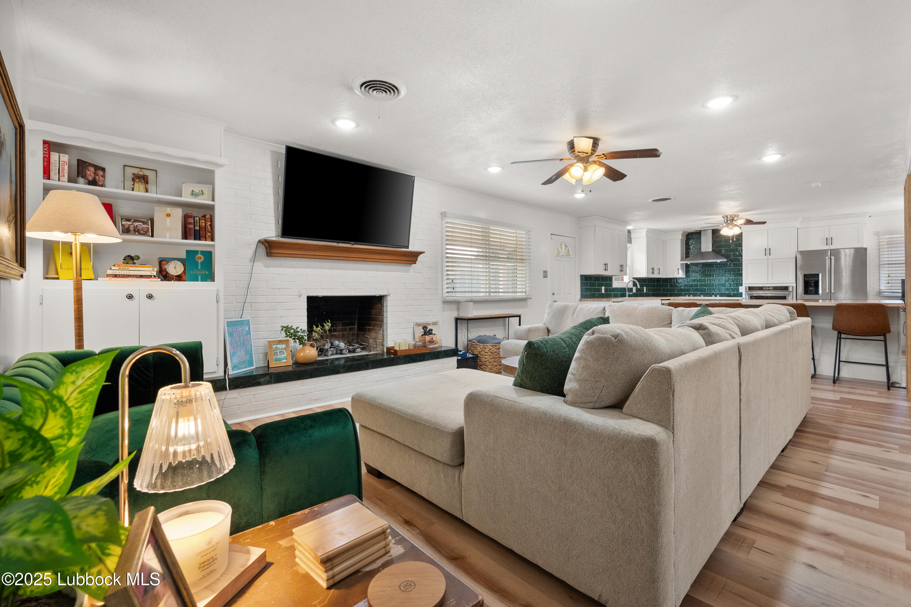 6405 Joliet Avenue Lubbock, TX 79413 - Photo 12 of 30 a living room with furniture fireplace and flat screen tv