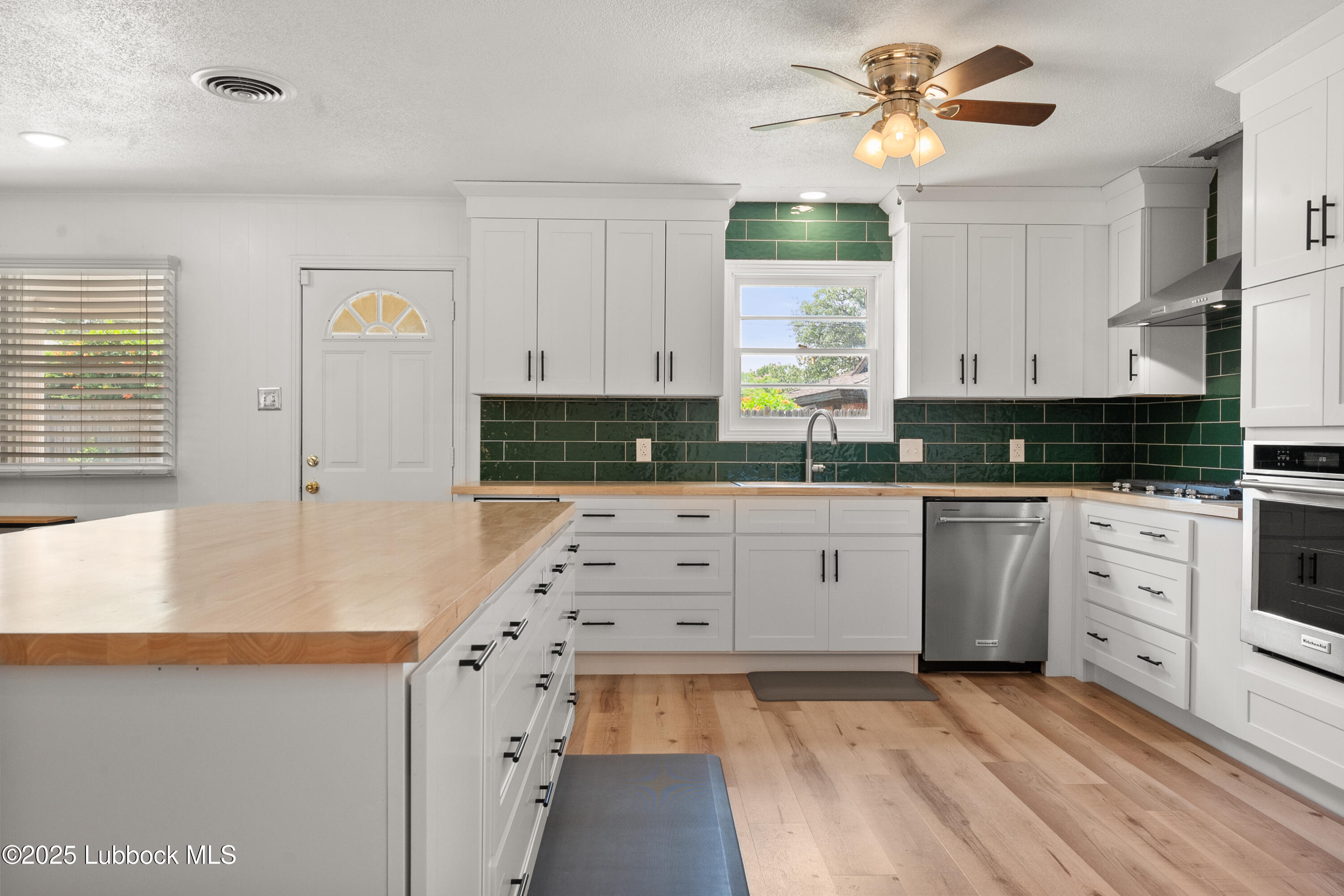 6405 Joliet Avenue Lubbock, TX 79413 - Photo 17 of 30 a kitchen with cabinets appliances and a window