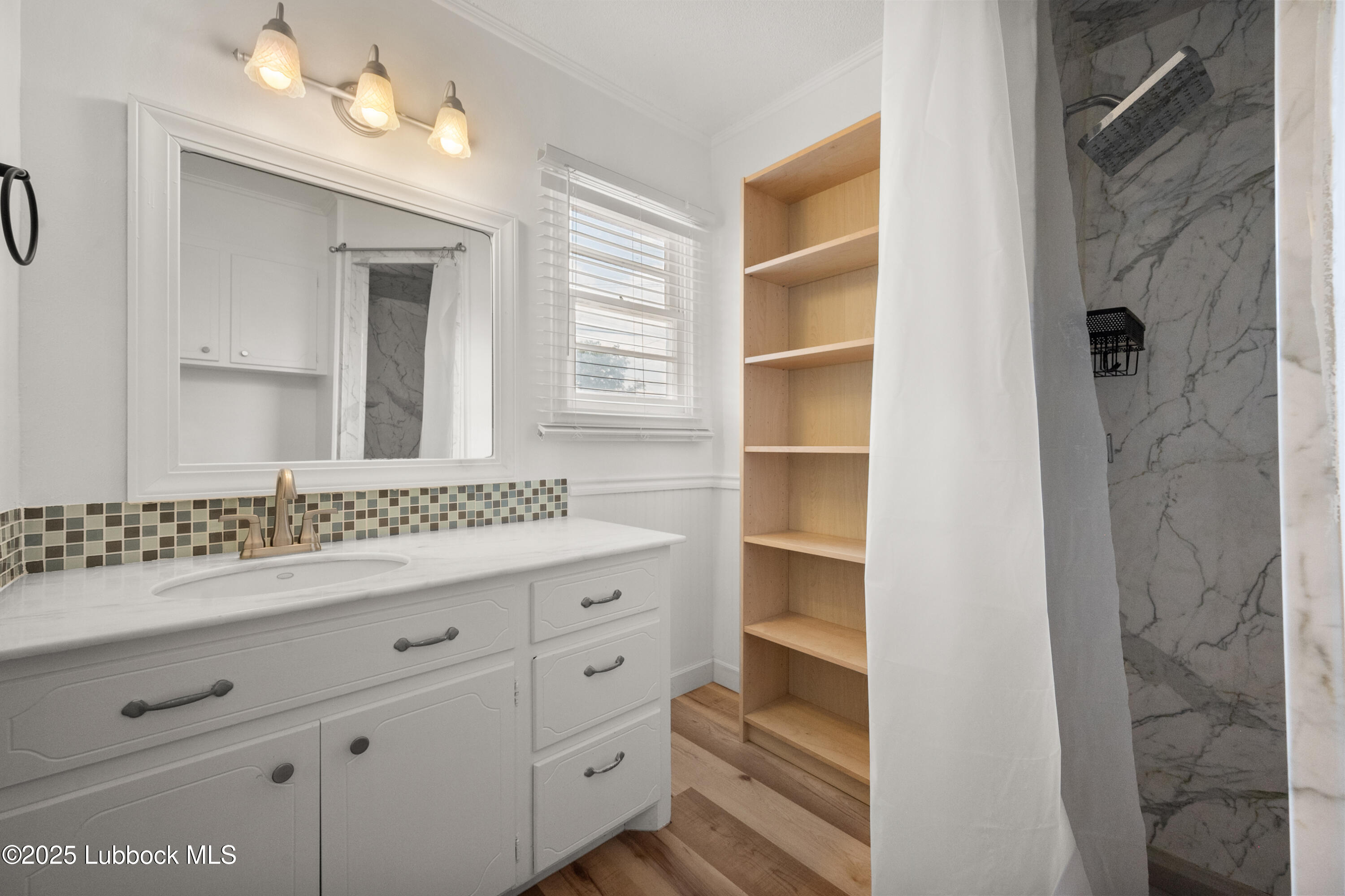 6405 Joliet Avenue Lubbock, TX 79413 - Photo 23 of 30 a bathroom with a double vanity sink and mirror