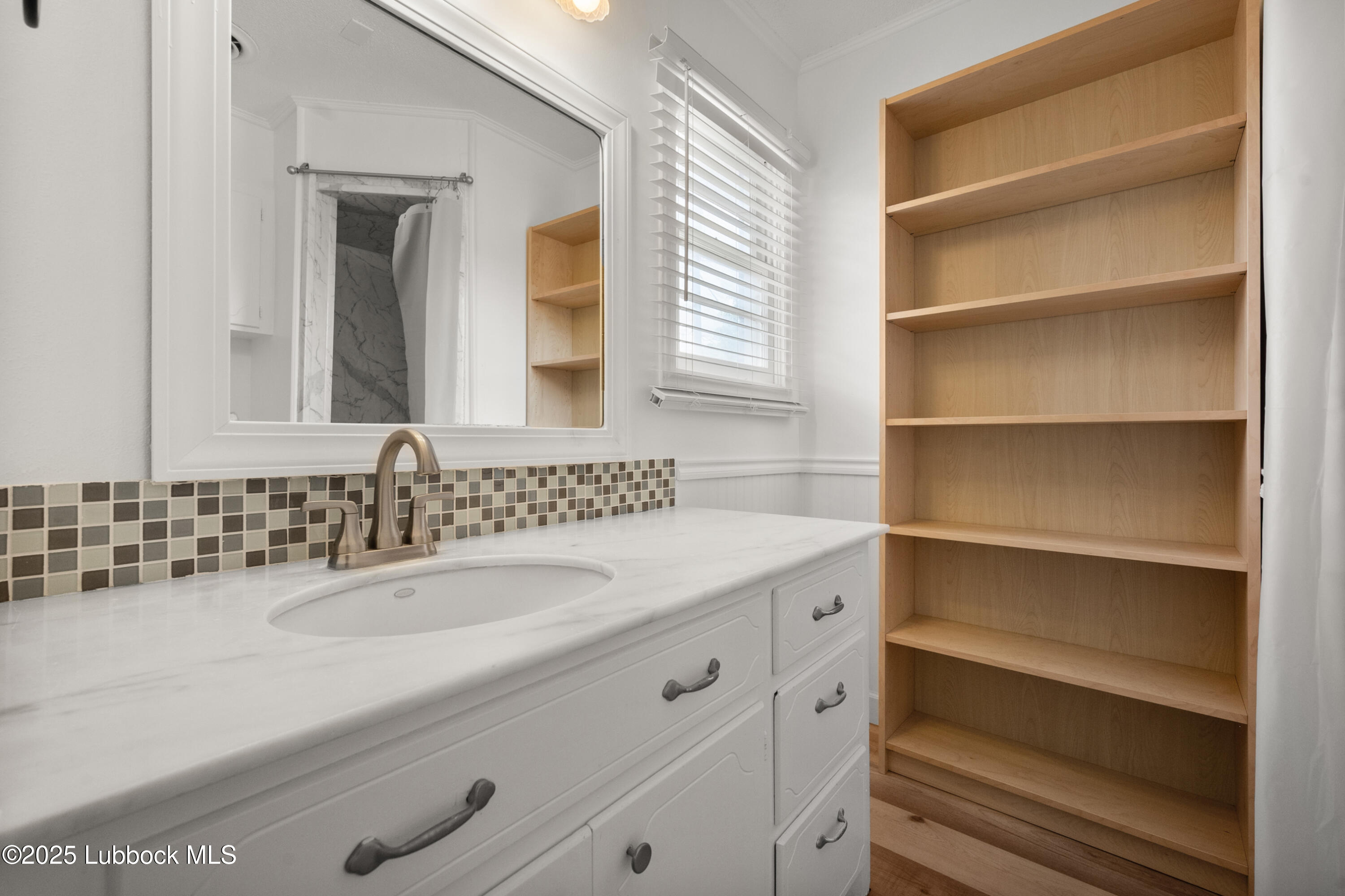 6405 Joliet Avenue Lubbock, TX 79413 - Photo 24 of 30 a bathroom with a sink and a mirror