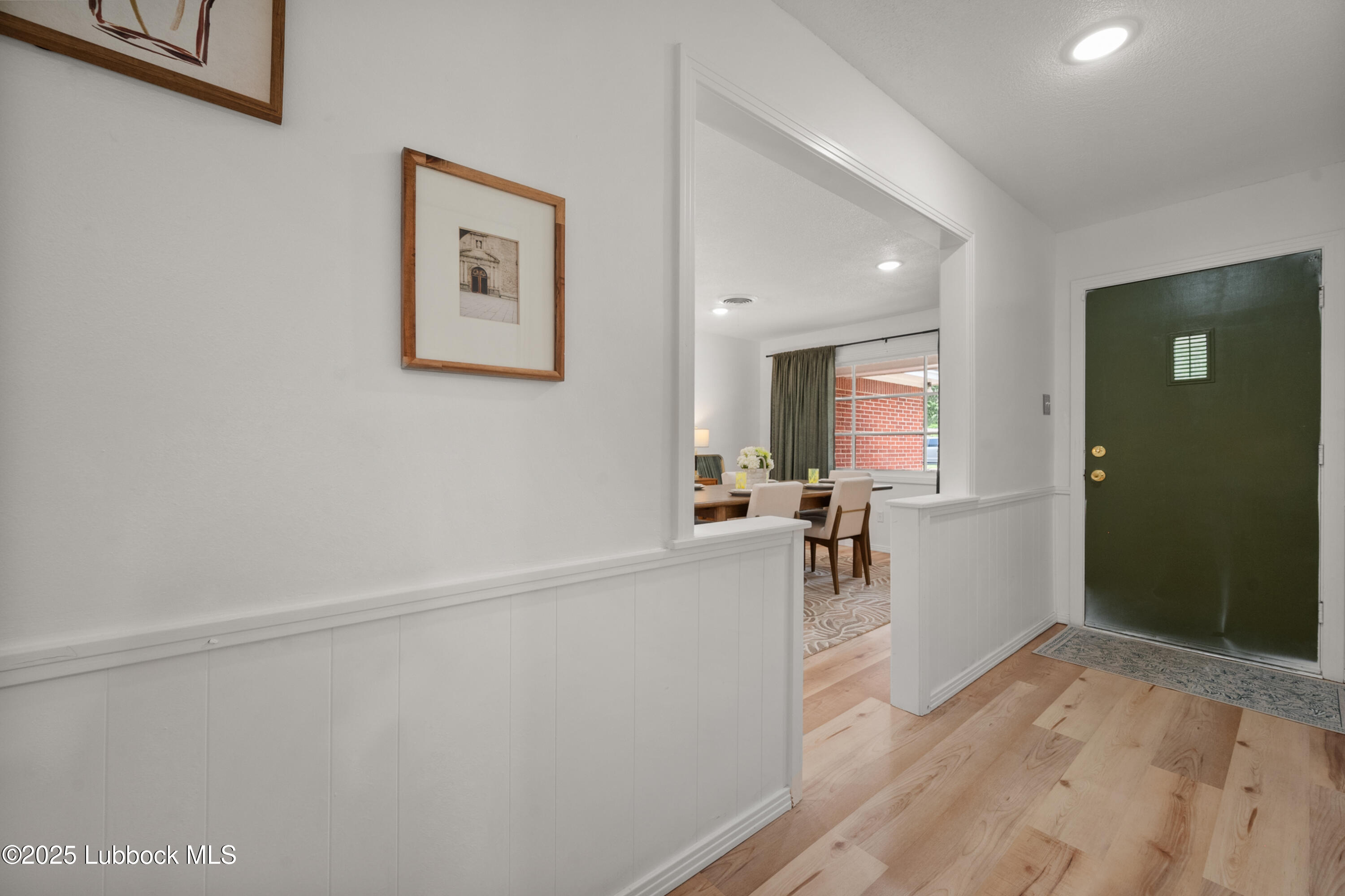 6405 Joliet Avenue Lubbock, TX 79413 - Photo 4 of 30 a view of a hallway with wooden floor and a living room