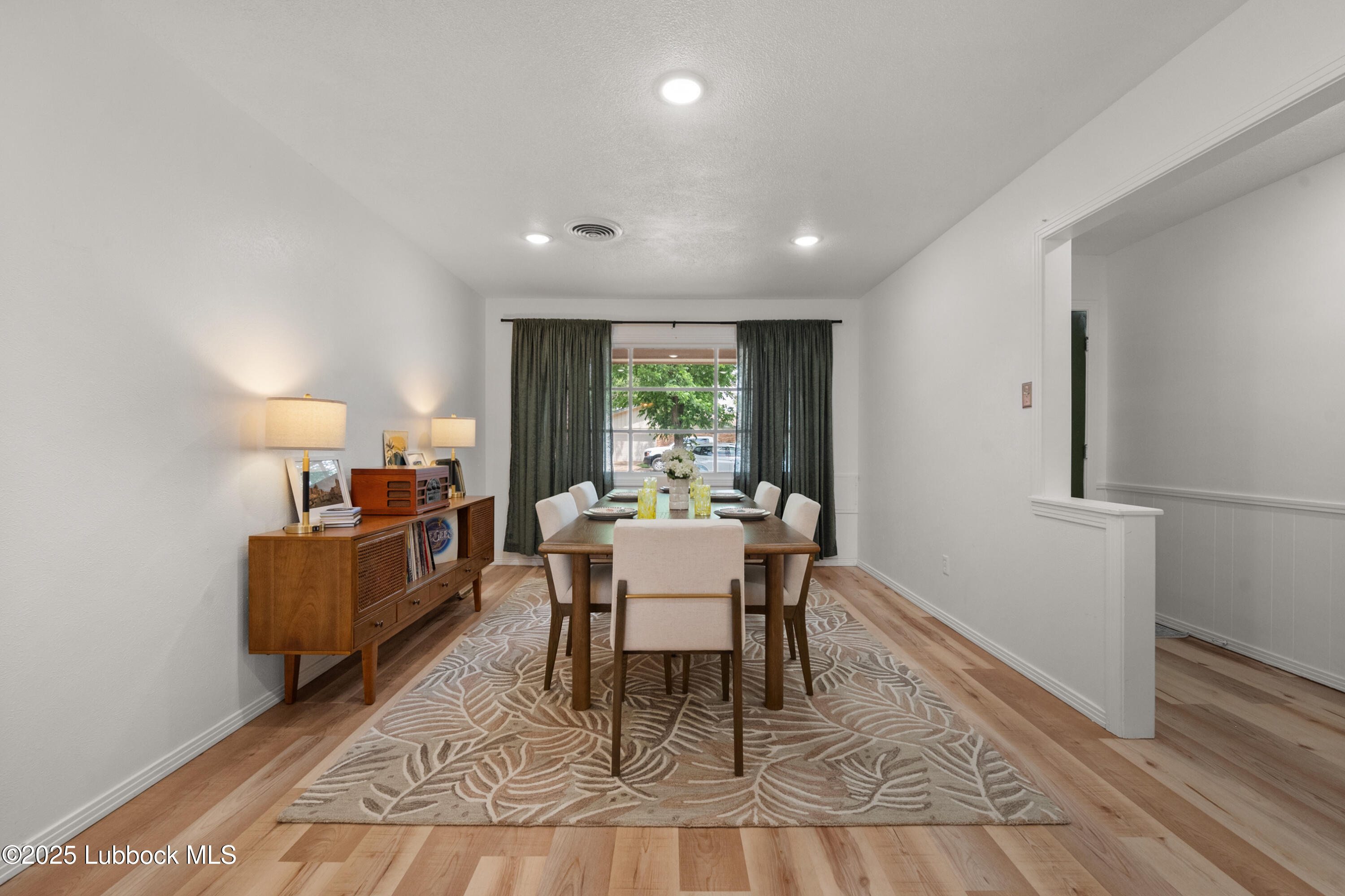 6405 Joliet Avenue Lubbock, TX 79413 - Photo 5 of 30 a dining room with furniture and wooden floor