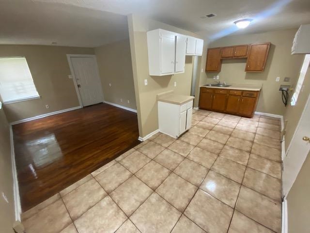 4370 Range Line Road Memphis, TN 38127 - Photo 8 of 14 Kitchen featuring light hardwood / wood-style flooring, white cabinetry, and sink