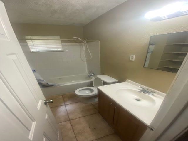 4370 Range Line Road Memphis, TN 38127 - Photo 9 of 14 Full bathroom with bathing tub / shower combination, a textured ceiling, toilet, vanity, and tile patterned flooring