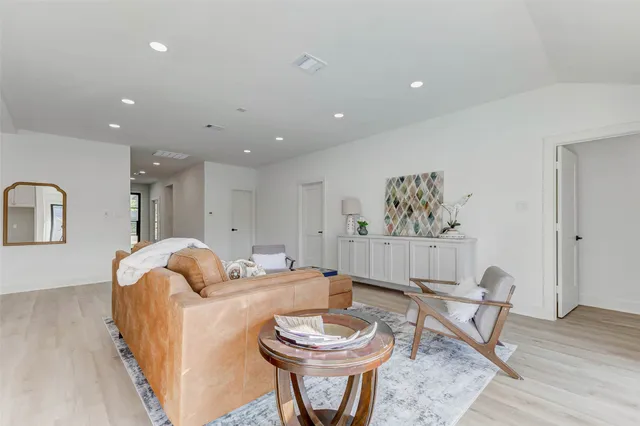 a living room with furniture a window and a table