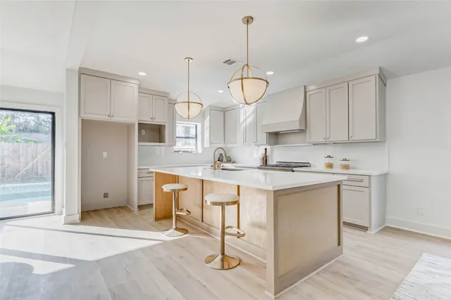 a view of living room with granite countertop furniture a sink a window and appliances