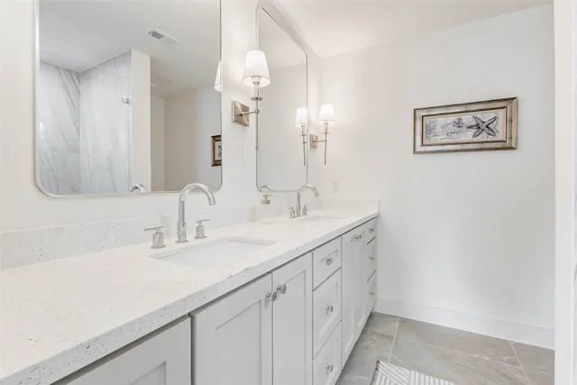 a bathroom with a double vanity sink and a mirror