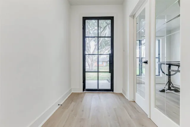 an empty room with windows and closet