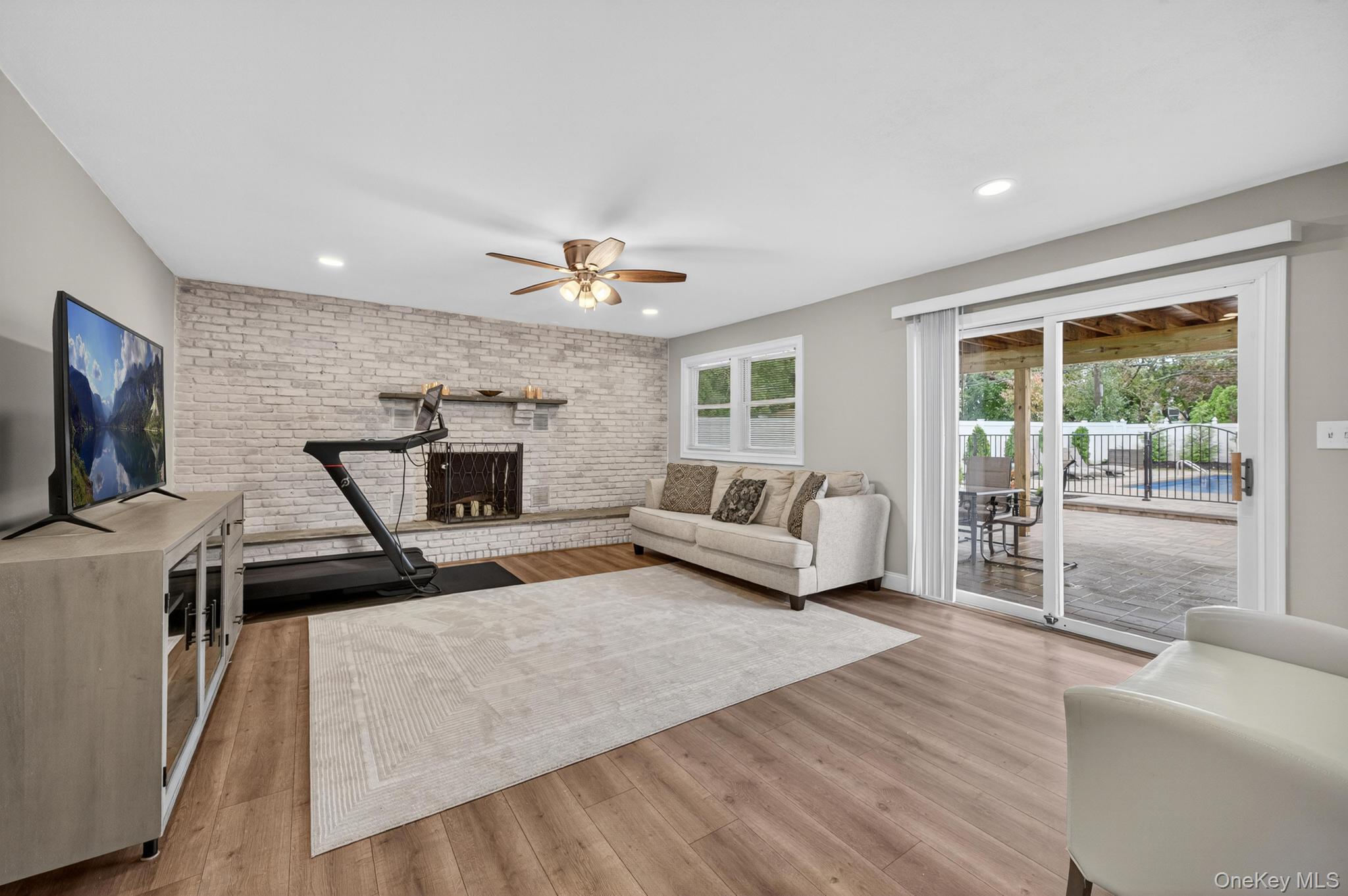 12 Farmstead Road Commack, NY 11725 - Photo 24 of 28 a living room with furniture and a flat screen tv