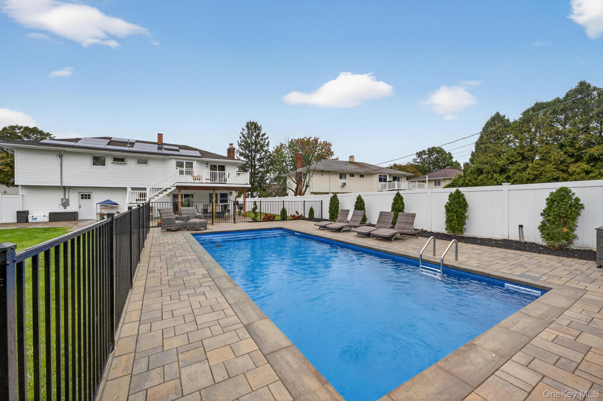 12 Farmstead Road Commack, NY 11725 - Photo 26 of 28 a view of a swimming pool with a lounge chairs