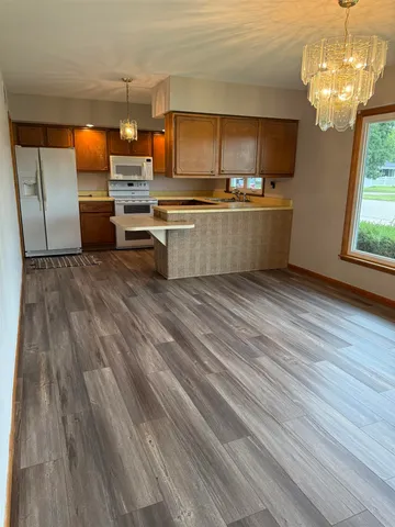 a kitchen with stainless steel appliances a refrigerator and a stove top oven