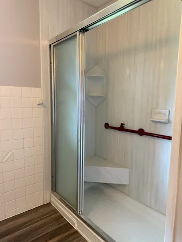 a bathroom with a glass shower door