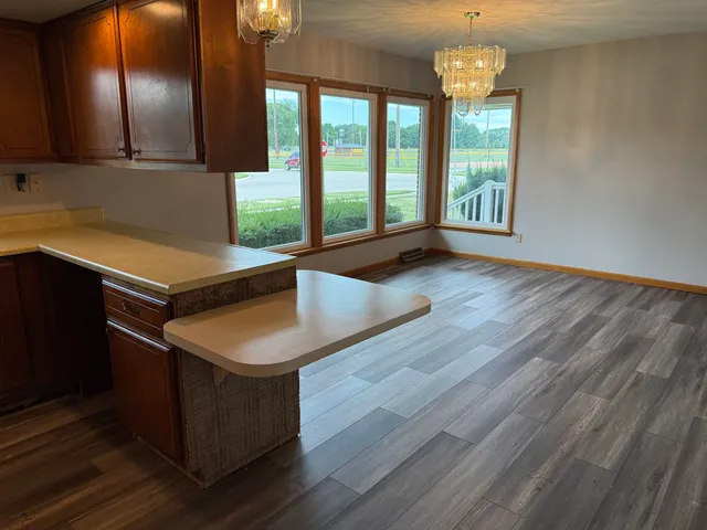 a room with pool table and windows