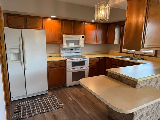 a kitchen with a sink stainless steel appliances a counter space and a window