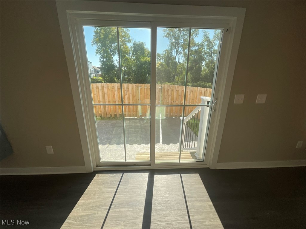 4659 Newcomer Road Kent, OH 44240 - Photo 21 of 23 Doorway to outside featuring a wealth of natural light and dark wood-type flooring