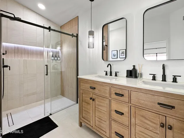 a spacious bathroom with double sink and shower