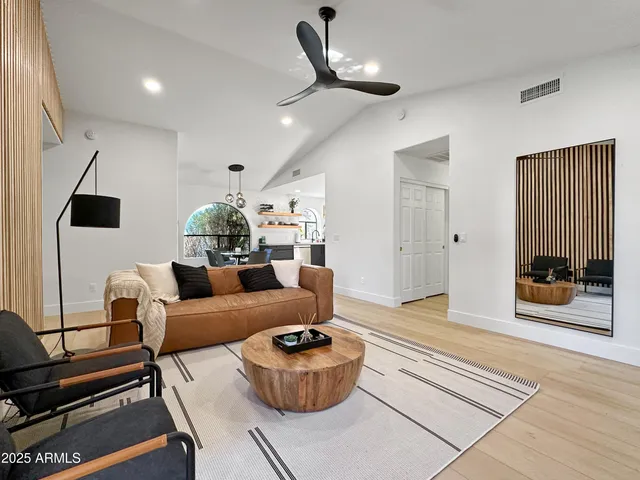 a living room with furniture and wooden floor