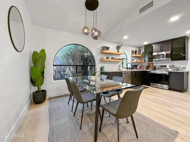 a dining room with furniture a window and wooden floor